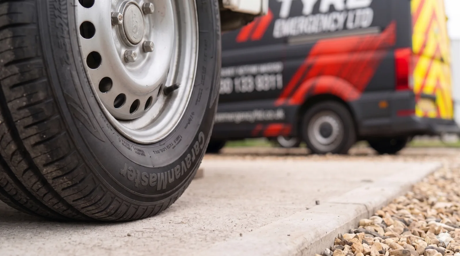 A Caravanmaster caravan tyre with the Tyre Emergency Ltd service van visible in the background