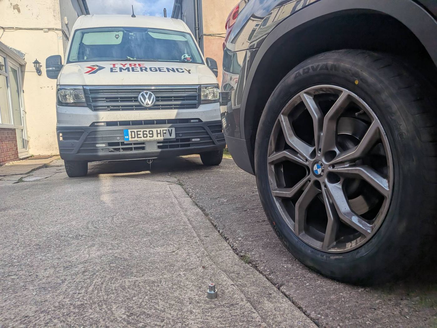 A BMW X3 on a driveway in Bilsthorpe with a new Yokohama Advan run-flat tyre fitted, the Tyre Emergency van parked behind it