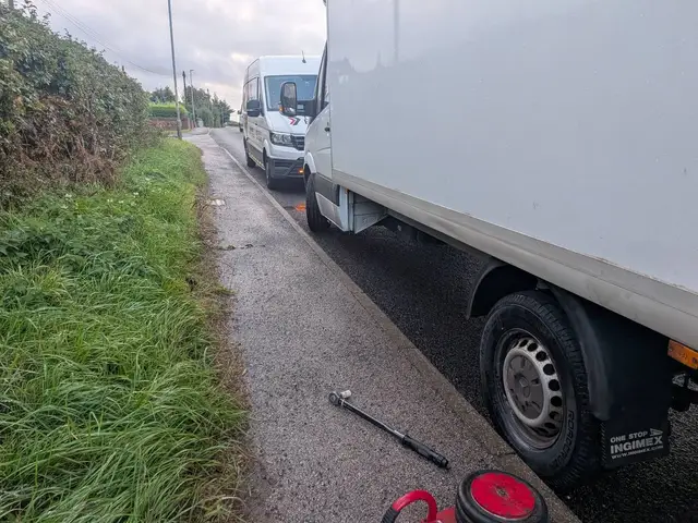 A white box van at the kerb on the Ollerton Road with its new tyre fitted, the Tyre Emergency van parked behind it and a torque wrench on the pavement